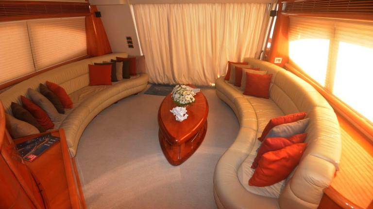 Semicircular soft sofas with pillows on the yacht